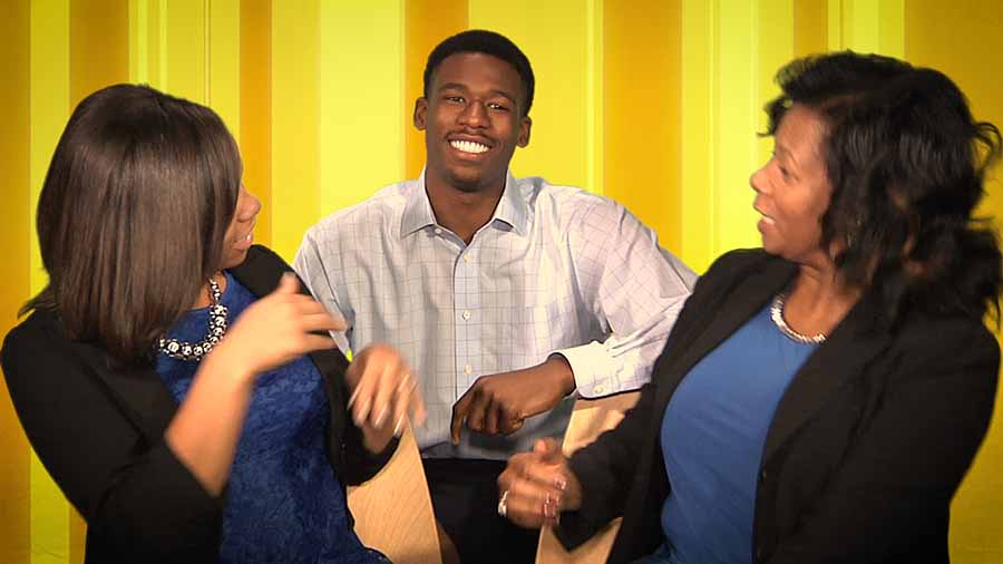 A mother and her son and daughter goofing around.