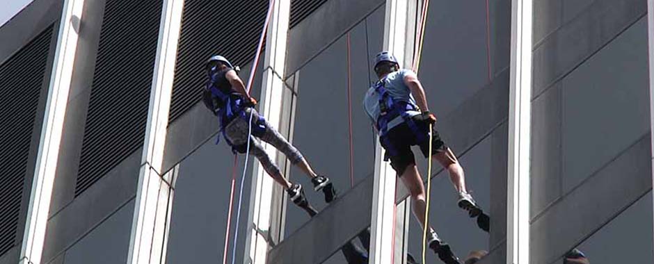 People rappelling down the side of a bank in downtown Raleigh, North Carolina during a fund raising event.