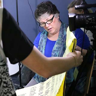 Photo of Kim directing a video shoot.