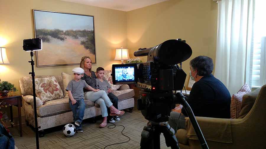 A mother and her two sons being interviewed at a Ronald McDonald House.