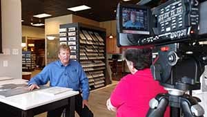 A man being interviewed in a tile store.