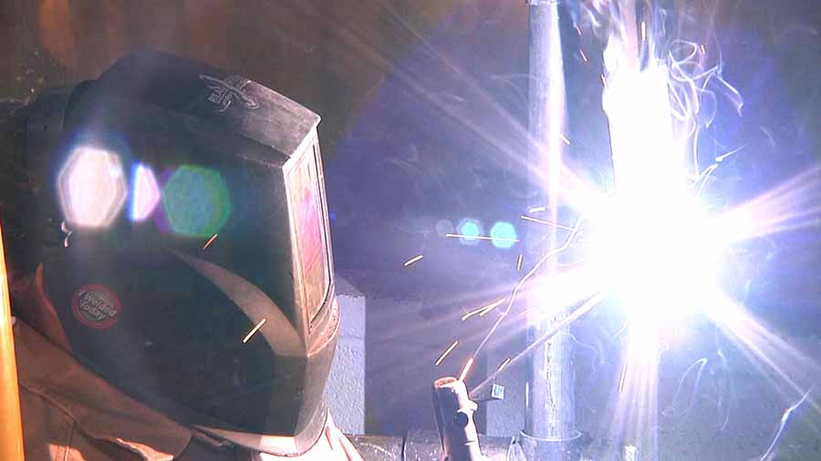A student welding at school.