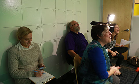 Photo of our crew and our clients laughing during video shoot.